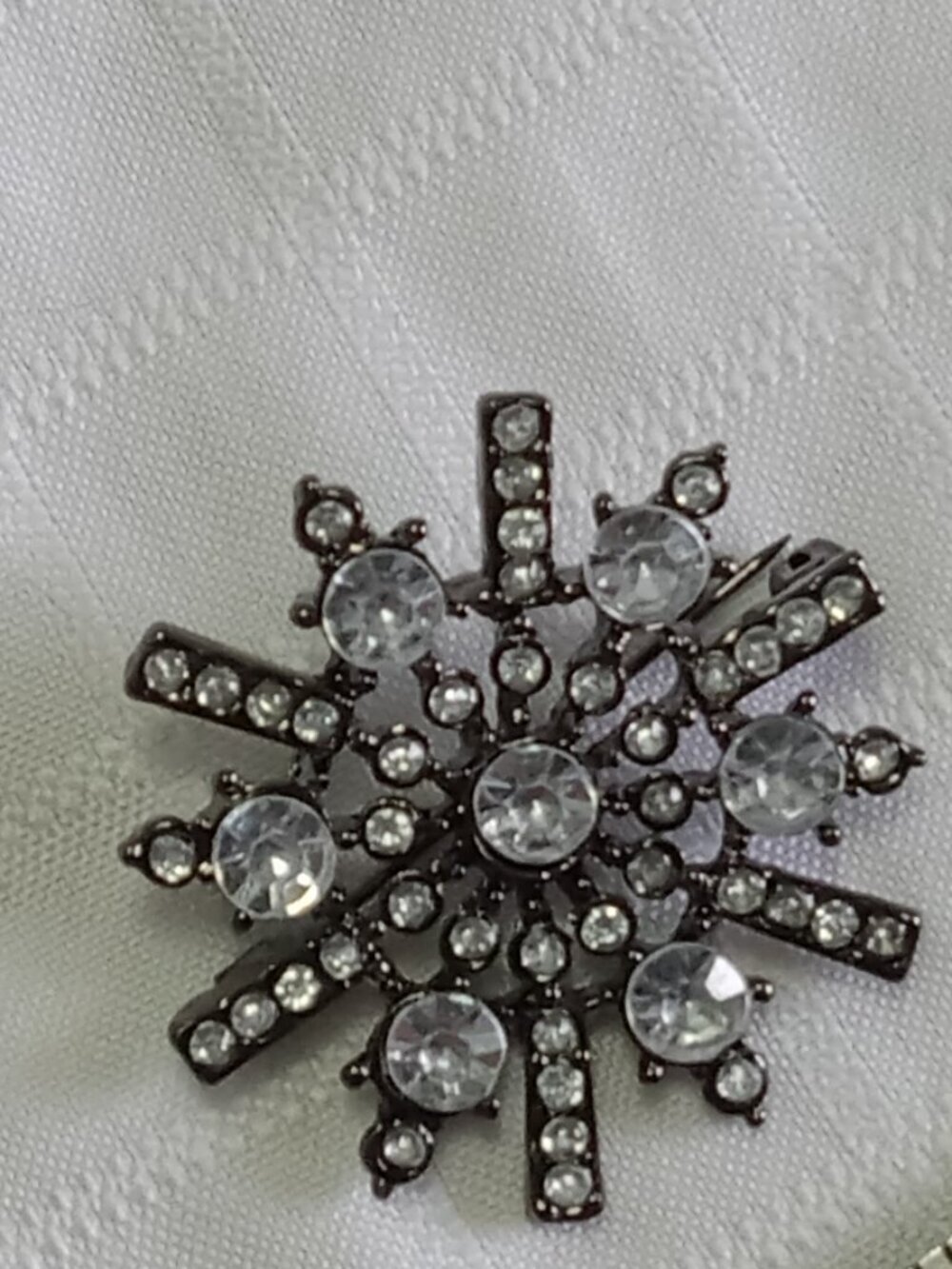 Two stunning vintage silver and egg-white colored brooches with inlays